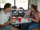Paul Bryant, N5PB gives Sarah Strautmann, KG4KHX some pointers while she operates 20 meters.  Sarah, 17 is a member of the 4-H Club who received her license along with two of her younger sisters in the fall of 2001.