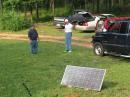 The bright Georgia sun allowed us to charge a battery for alternate power contacts.  In the background planning a Carolina Windom placement are David (N5FB) and Jim (K4LCP)
