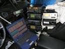 The business side of how this all gets done :
The view from the Drivers 8-way electrically adjusted power seat, with heated surfaces for those chilly contesting evenings.
Not shown are the additional switchboxes and transverters behind the pile of radios on the passenger floorboard.