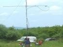 The K4KDJ "<i>intelligent antenna rotator</i>" -- Alex, KI4PCA, helps peak up the 144/432 mast on a station to the west, getting his cues from the operating tent, just out of frame to the left.