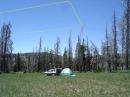 272 ft. horizontal wire loop antenna fed with 400 ohm feedline and elevated 60 ft. above tent.  (wires highlighted in picture for better visibility)