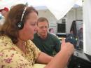 Cleo, KC7TTM, operating 20 phone as Bruce, KE7BWN, studies QSO technique.