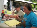 Mike, KE7GVA, hands out 40 phone contacts while Peggy, KE6TIS, logs.
