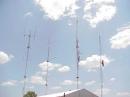 Bunkhouse, Towers, and Antennas on a Sunny Day. L to R, 2m tower, 6 meter tower, UHF tower, Internet and Telephone tower
